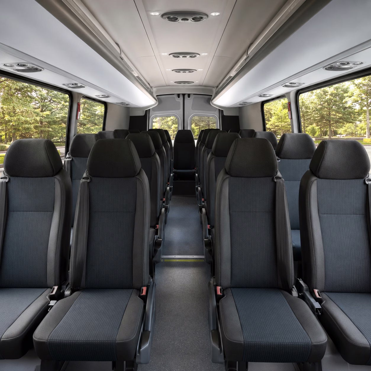 Corporate group with rolling luggage boarding a white charter bus