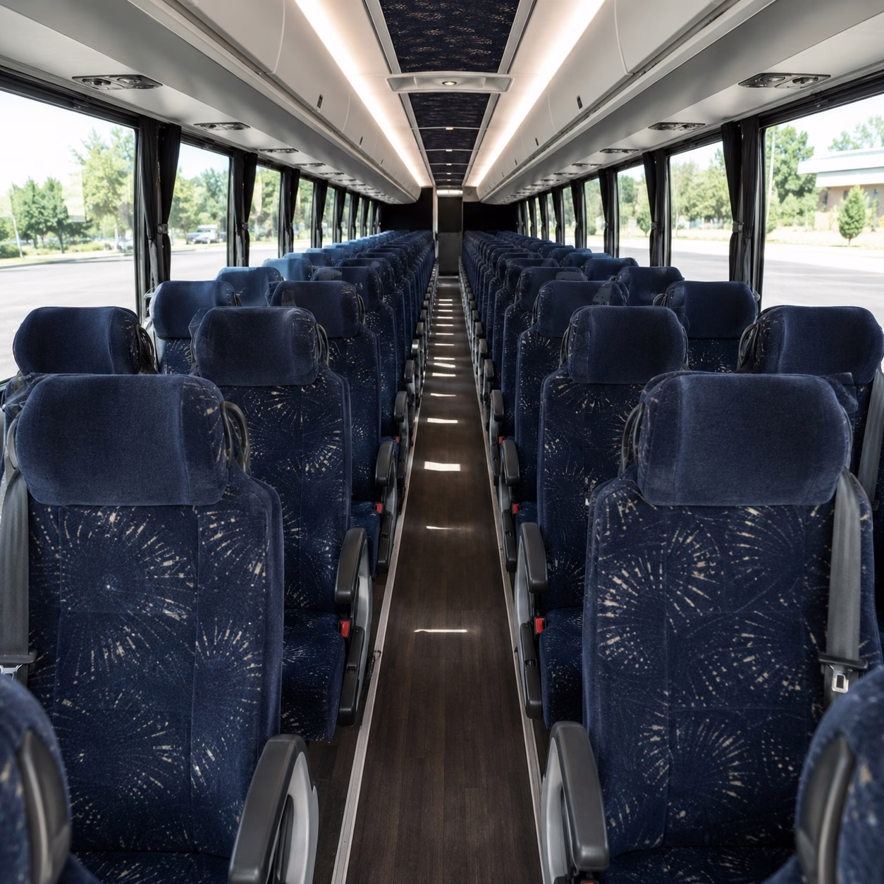 Interior aisle of a minibus with rows of cushioned passenger seats