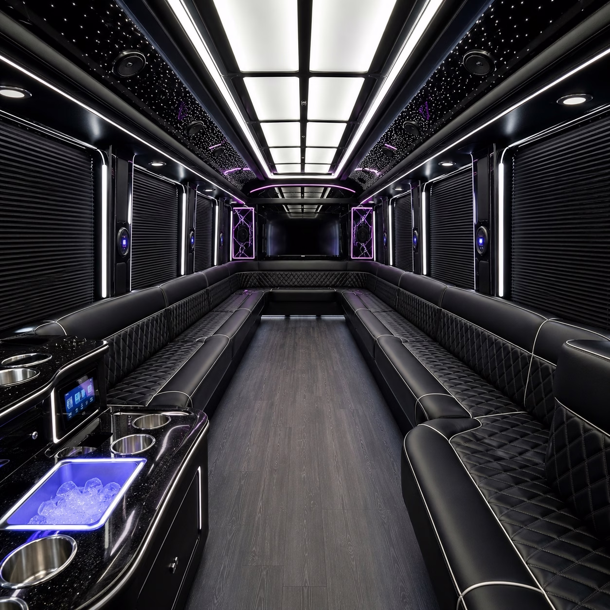 Interior of a party bus with wraparound leather seating and LED accent lighting