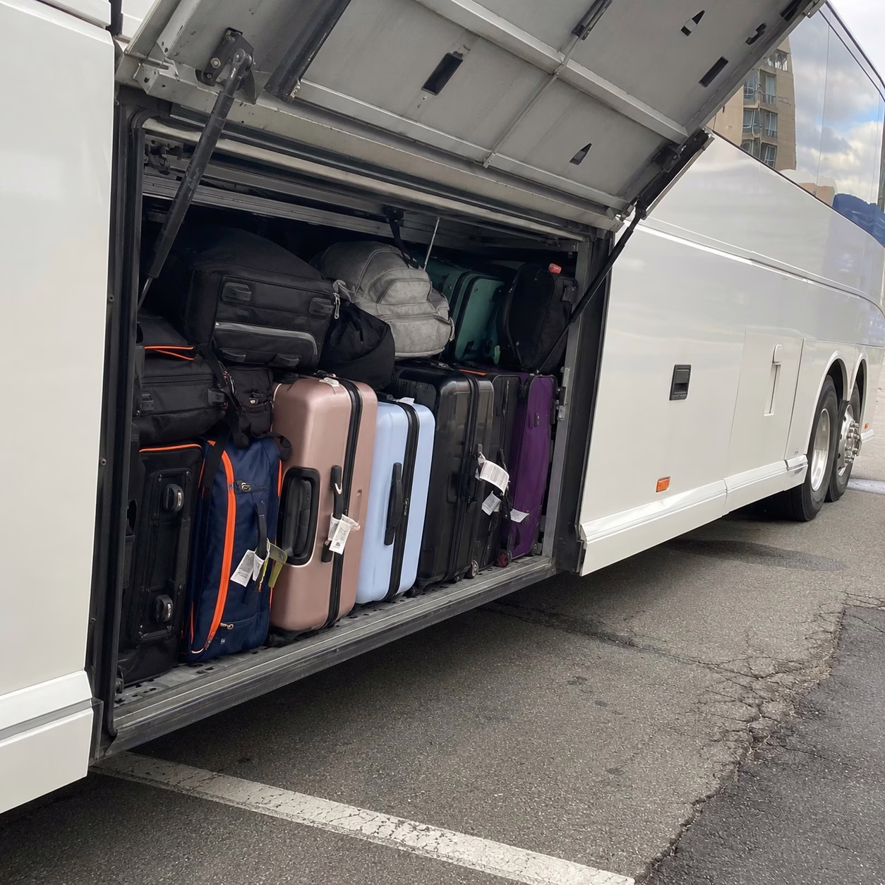 Luggage loaded into a Hampton Roads motorcoach luggage bay